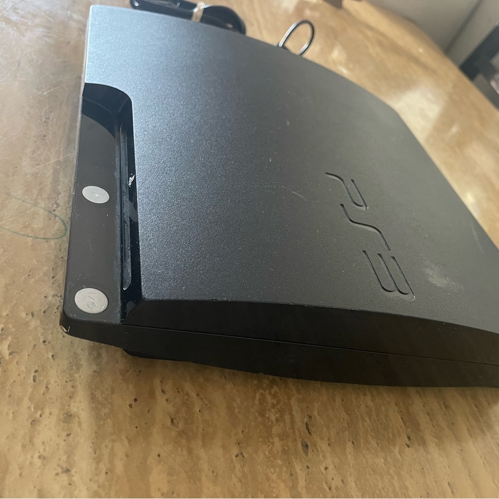 Play station 3 with games and a control.